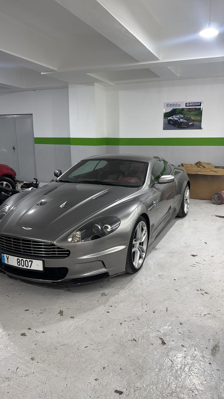 Silver Aston Martin inside the garage